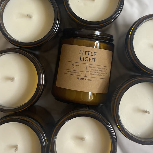 Faith-inspired candle on tabletop, representing compassion and the value of life.